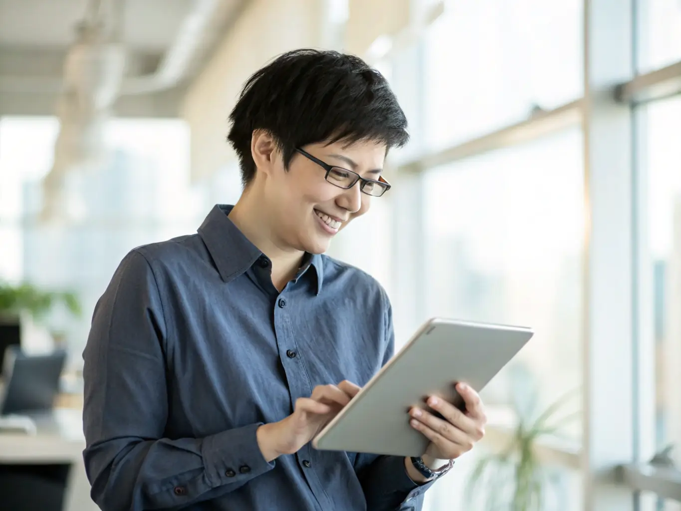 A small business owner reviewing real-time data analytics on a tablet, showcasing the insights gained from integrated systems, with a satisfied expression.